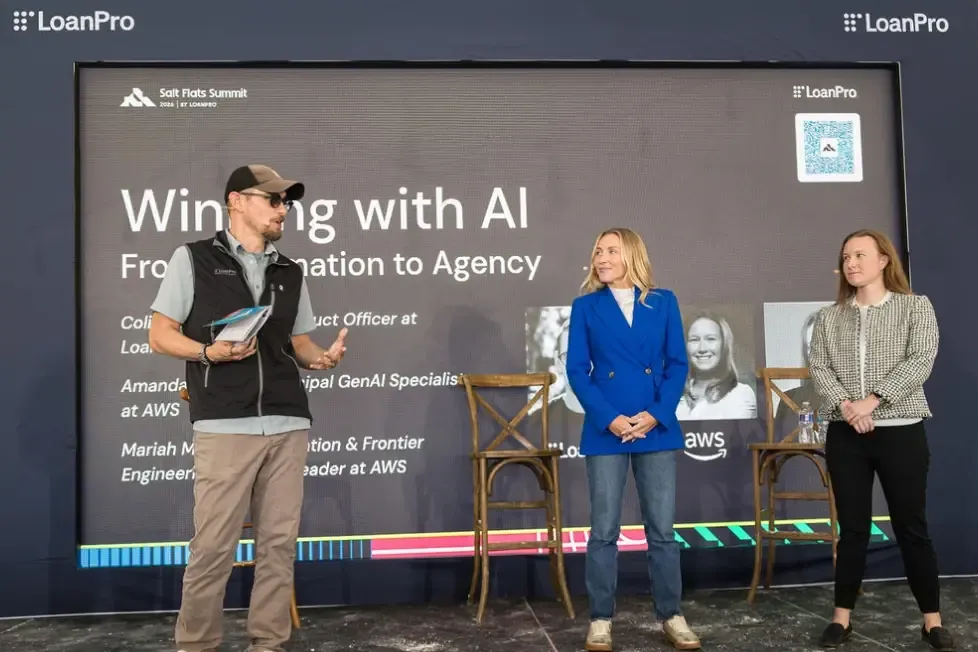 From left, LoanPro's Colin Terry with Mariah Miller and Amanda Lester of AWS on stage at the 2026 Salt Flats Summit panel on agentic AI in lending