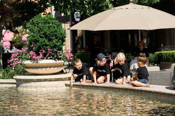 Children playing in the Station Park fountain in front of LoanPro Headquarters on opening day